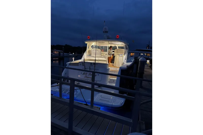 My Lucky Penny Yacht Photos Pics 2006 Tiara Yachts 4300 Sovran docked at night with illuminated interior.