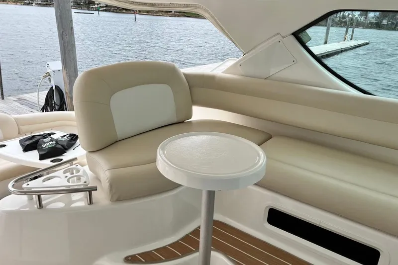 My Lucky Penny Yacht Photos Pics Luxurious interior of 2006 Tiara Yachts 4300 Sovran with beige seating and table.