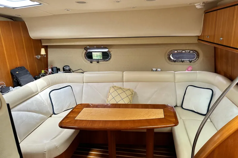 My Lucky Penny Yacht Photos Pics Luxurious interior of 2006 Tiara Yachts 4300 Sovran with elegant seating and wooden table.