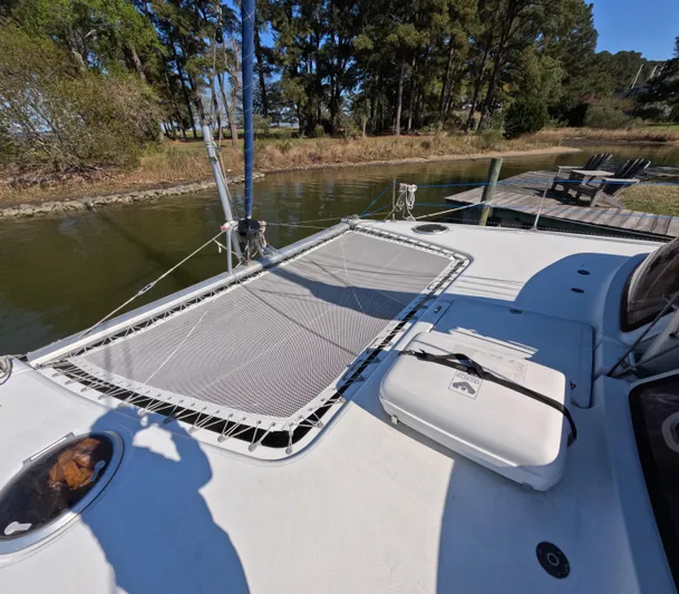 Quelle Belle Vie Yacht Photos Pics 2008 Fountaine Pajot Mahe 36 catamaran docked by a serene lakeside.