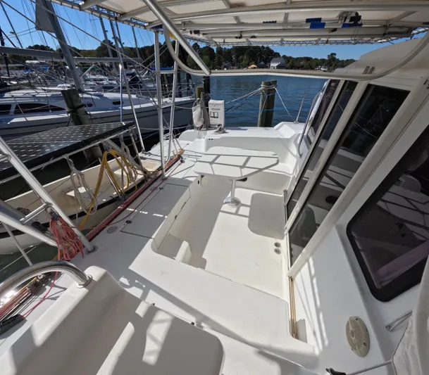 Quelle Belle Vie Yacht Photos Pics 2008 Fountaine Pajot Mahe 36 catamaran deck with seating and table, docked at marina.