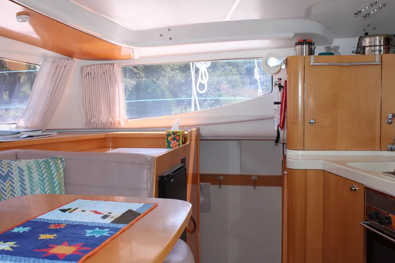 Quelle Belle Vie Yacht Photos Pics Interior of 2008 Fountaine Pajot Mahe 36 catamaran with cozy dining area and kitchen.