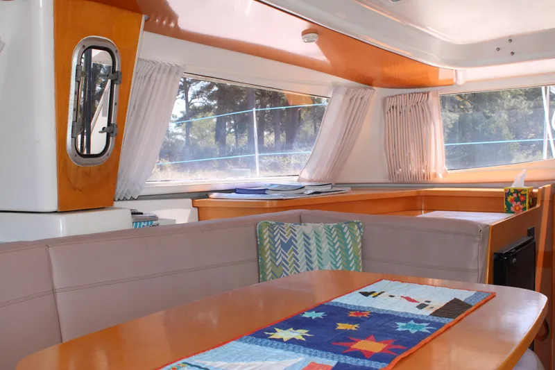 Quelle Belle Vie Yacht Photos Pics Interior of 2008 Fountaine Pajot Mahe 36 catamaran with dining area and large windows.