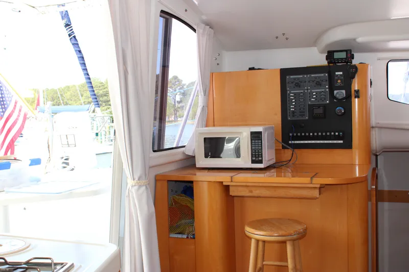 Quelle Belle Vie Yacht Photos Pics Interior of 2008 Fountaine Pajot Mahe 36 catamaran with microwave and control panel.