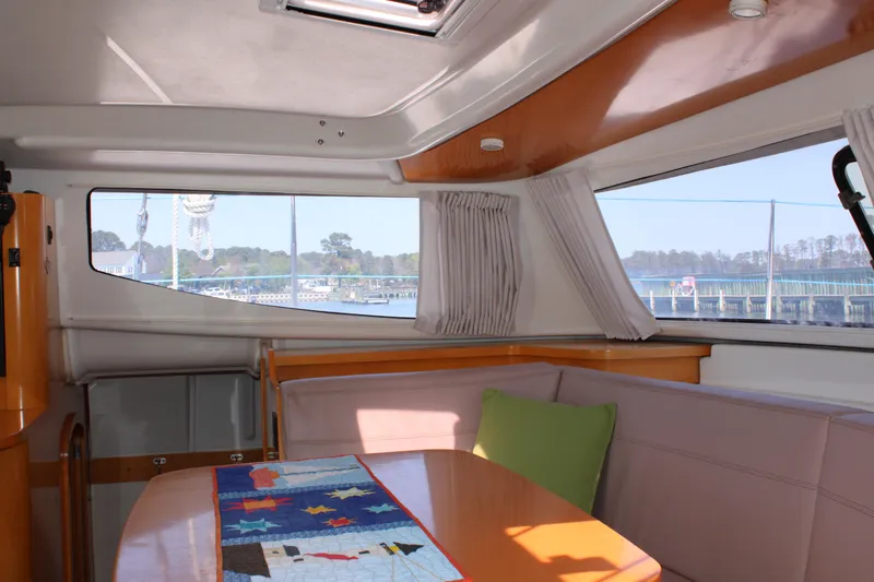 Quelle Belle Vie Yacht Photos Pics Interior of 2008 Fountaine Pajot Mahe 36 catamaran with dining area and large windows.