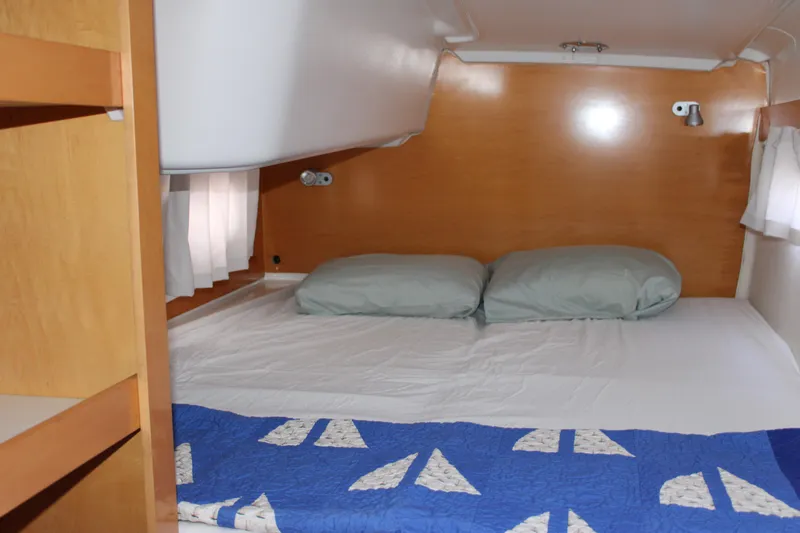 Quelle Belle Vie Yacht Photos Pics Cozy cabin interior of 2008 Fountaine Pajot Mahe 36 catamaran with bed and wooden finish.