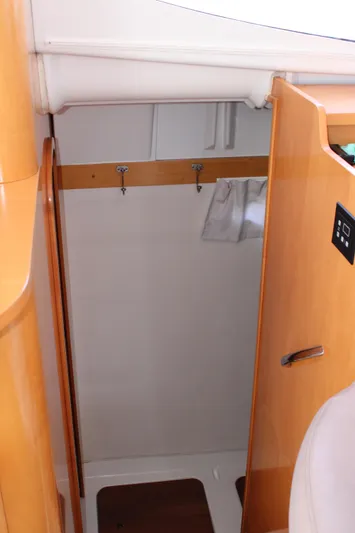 Quelle Belle Vie Yacht Photos Pics Interior view of 2008 Fountaine Pajot Mahe 36 sailboat, featuring wooden cabinetry and storage space.