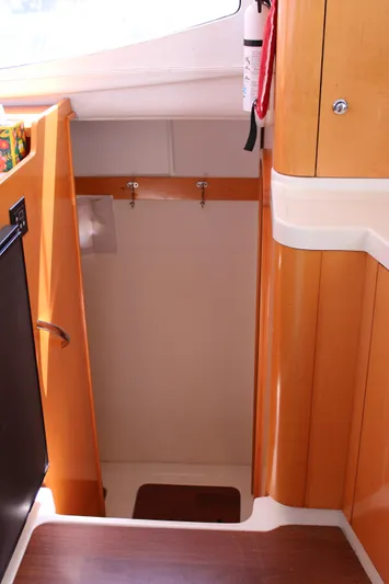 Quelle Belle Vie Yacht Photos Pics Interior view of 2008 Fountaine Pajot Mahe 36 yacht, featuring wooden cabinetry and stairs.