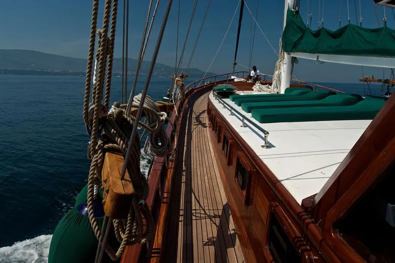  Yacht Photos Pics Classic 2006 Caicco ERDAL SOGUTCUK yacht sailing on calm sea with wooden deck.
