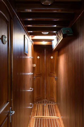  Yacht Photos Pics Wood-paneled hallway inside 2006 Classic Caicco ERDAL SOGUTCUK yacht, featuring elegant doors and lighting.