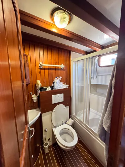  Yacht Photos Pics Classic 2006 Caicco ERDAL SOGUTCUK yacht bathroom with wooden paneling and shower.