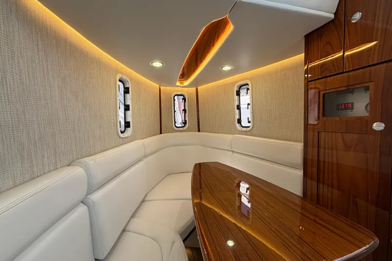  Yacht Photos Pics Luxurious interior of 2022 HCB 42 Lujo boat with elegant seating and wood finishes.