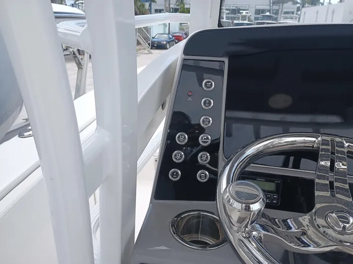 266 -105 Yacht Photos Pics 2023 Robalo 266 Cayman SD boat dashboard with steering wheel and control panel.