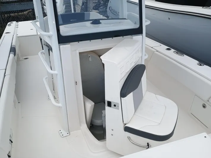 266 -105 Yacht Photos Pics 2023 Robalo 266 Cayman SD boat interior with seating and storage area.