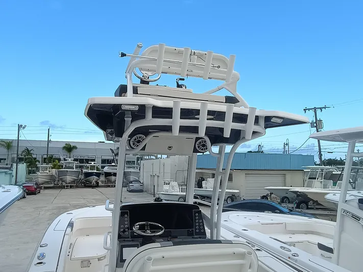 266 -105 Yacht Photos Pics 2023 Robalo 266 Cayman SD boat with elevated helm station and clear blue sky.