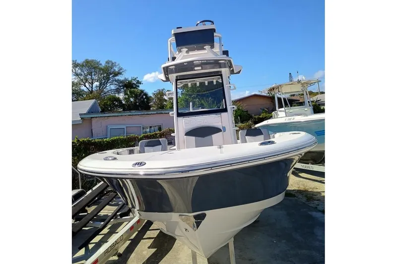 266 -105 Yacht Photos Pics 2023 Robalo 266 Cayman SD boat, docked outdoors, showcasing sleek design and modern features.