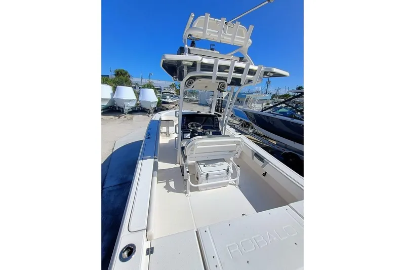 266 -105 Yacht Photos Pics 2023 Robalo 266 Cayman SD boat with center console and T-top in a marina setting.