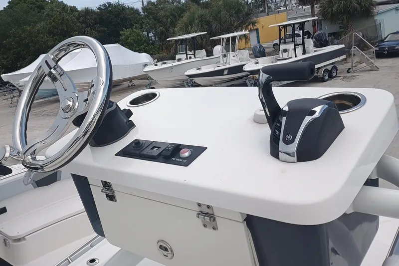 266 -105 Yacht Photos Pics 2023 Robalo 266 Cayman SD boat console with steering wheel and controls.