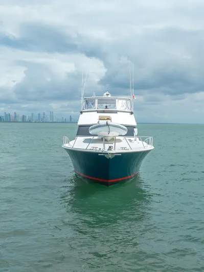 Tam Tam Yacht Photos Pics 1997 Viking 58 Convertible yacht on open water with city skyline.