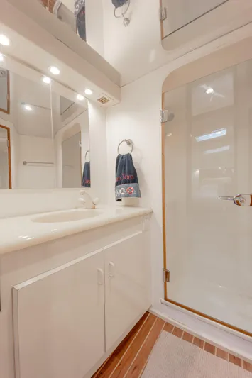 Tam Tam Yacht Photos Pics 1997 Viking 58 Convertible yacht bathroom with white vanity and enclosed shower.