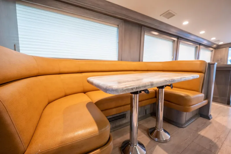 Hatts Off Yacht Photos Pics Luxurious interior of 1998 Hatteras 74 Cockpit Motor Yacht with plush seating and table.