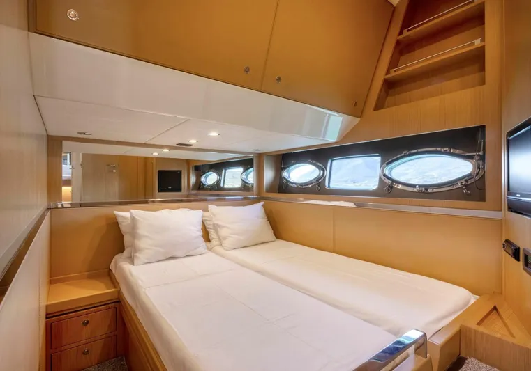  Yacht Photos Pics Luxurious cabin interior of 2009 Riva Sportriva yacht with twin beds and porthole windows.