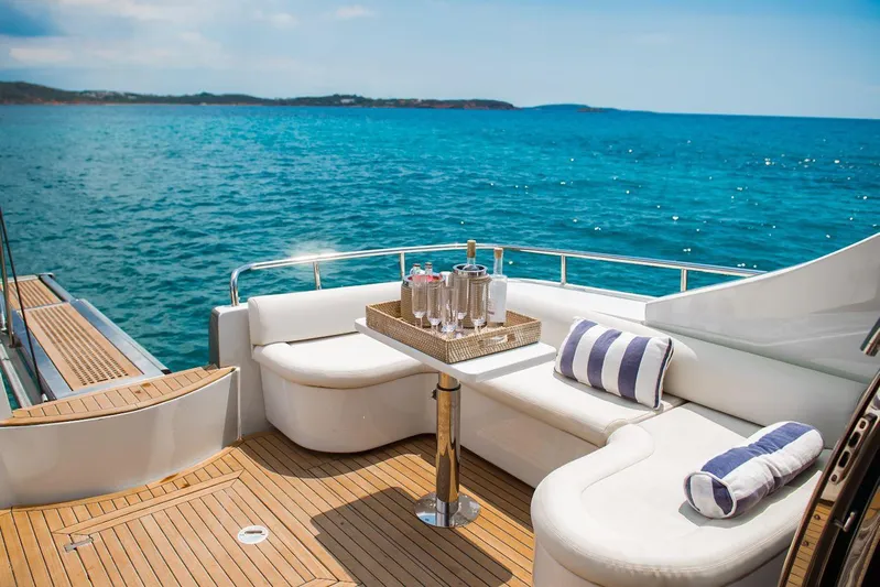  Yacht Photos Pics Luxurious 2003 Pershing 65 yacht deck with ocean view, featuring elegant seating and refreshments.