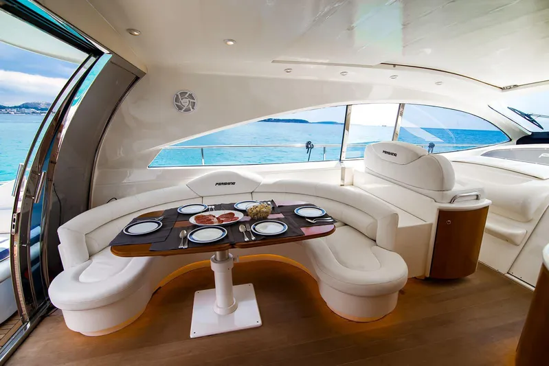  Yacht Photos Pics Luxurious interior of 2003 Pershing 65 yacht with elegant dining area and ocean view.