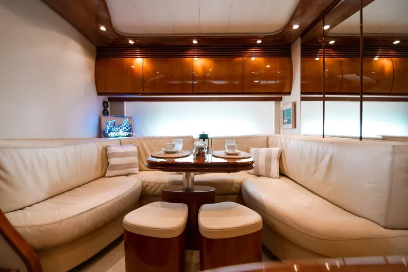  Yacht Photos Pics Luxurious interior of a 2003 Pershing 65 yacht with elegant seating and dining area.