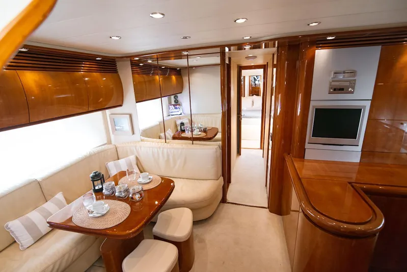  Yacht Photos Pics Luxurious interior of a 2003 Pershing 65 yacht with elegant wood finishes and cozy seating.