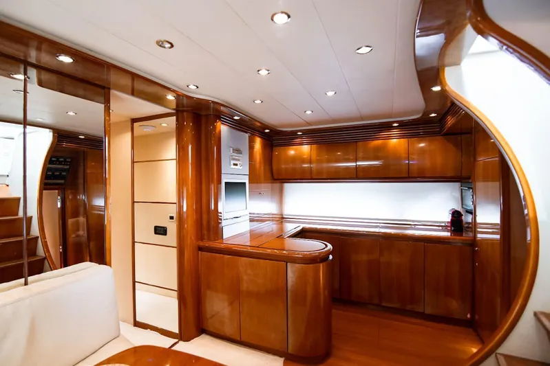  Yacht Photos Pics Luxurious interior of 2003 Pershing 65 yacht with polished wood finishes.