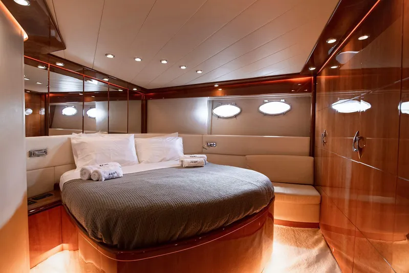  Yacht Photos Pics Luxurious bedroom interior of 2003 Pershing 65 yacht with elegant wood paneling.