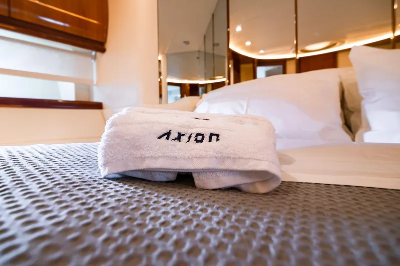  Yacht Photos Pics Luxurious bedroom interior on a 2003 Pershing 65 yacht with plush bedding and towel.