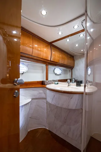  Yacht Photos Pics Luxurious bathroom interior of 2003 Pershing 65 yacht with wood and marble finishes.
