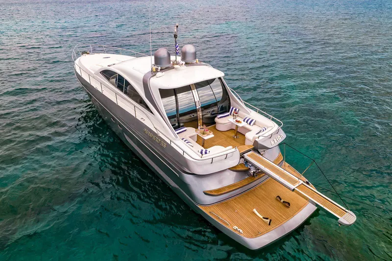  Yacht Photos Pics Luxury Pershing 65 yacht from 2003 on clear blue water, featuring elegant deck seating.