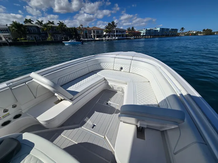  Yacht Photos Pics 2019 Intrepid 327 boat on calm water with luxurious seating area.