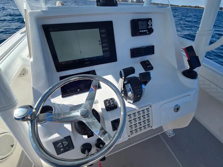  Yacht Photos Pics Helm console of a 2019 Intrepid 327 boat on the water.