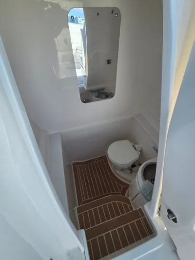  Yacht Photos Pics Interior of a 2019 Intrepid 327 yacht with toilet and mirror.