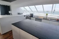 Modern kitchen interior on 2023 Custom 22m Catamaran with ocean view.