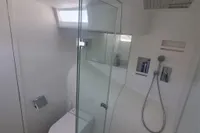Modern bathroom on 2023 Custom 22m Catamaran with glass shower and sleek fixtures.