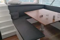 Modern interior of 2023 Custom 22m Catamaran with seating and ocean view.