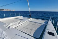 2023 Custom 22m Catamaran on open sea with clear blue sky.