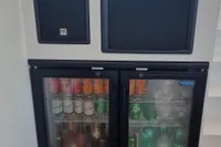 Mini fridge stocked with beverages on a 2023 Custom 22m Catamaran.