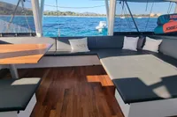Luxurious interior of 2023 Custom 22m Catamaran with ocean view and comfortable seating.