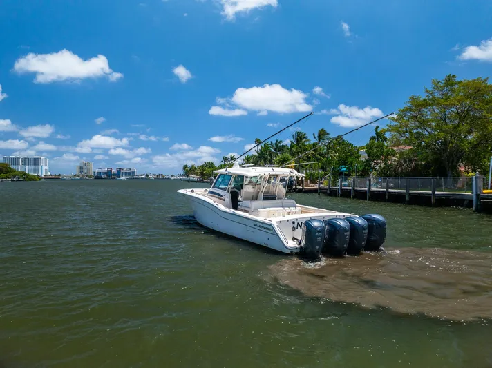 Yacht Photos Pics 2019 Grady-White Canyon 456 boat cruising on a sunny day with clear skies.