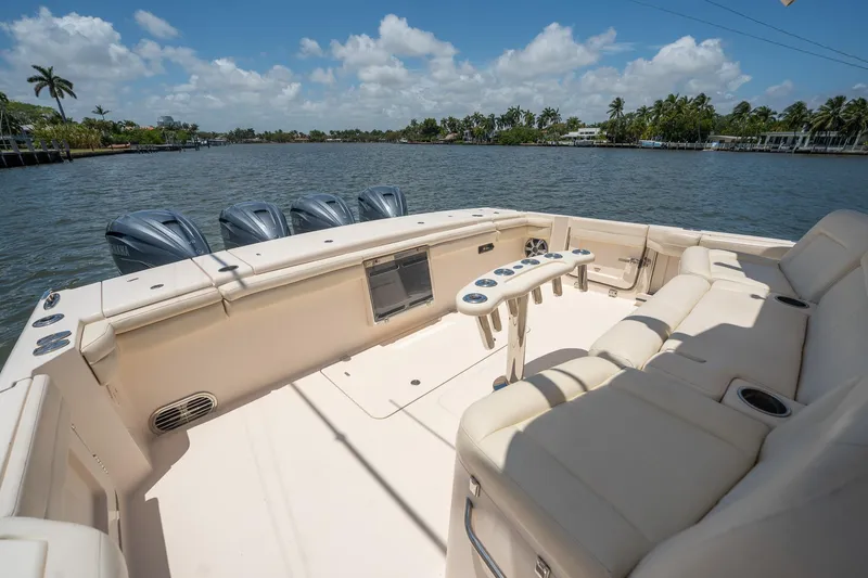  Yacht Photos Pics 2019 Grady-White Canyon 456 boat interior with seating, on a sunny day by the water.