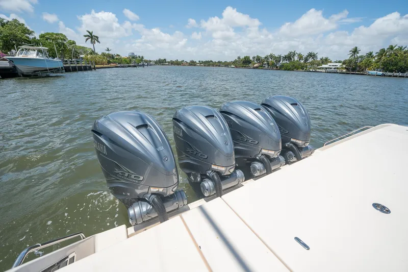  Yacht Photos Pics Four powerful outboard motors on a 2019 Grady-White Canyon 456 boat, cruising on a sunny day.