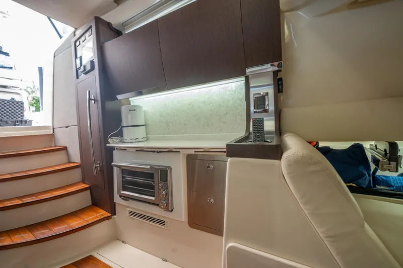  Yacht Photos Pics 2019 Grady-White Canyon 456 interior with modern kitchen amenities and wooden stairs.