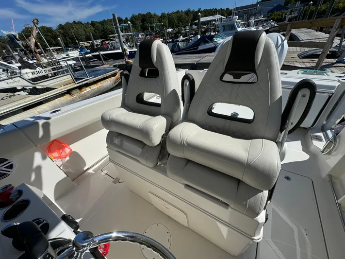  Yacht Photos Pics 2023 Sailfish 312 CC boat with dual cushioned seats at a marina.