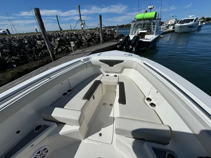  Yacht Photos Pics 2023 Sailfish 312 CC boat interior with seating, docked by the water.